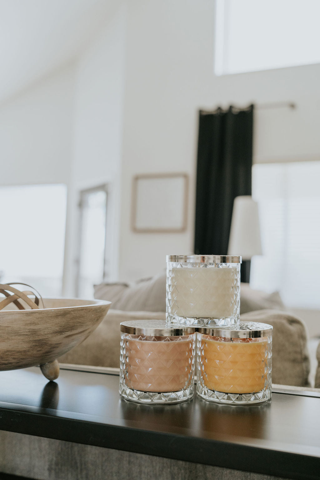 Three Gold Canyon soy candles stacked on a shelf.