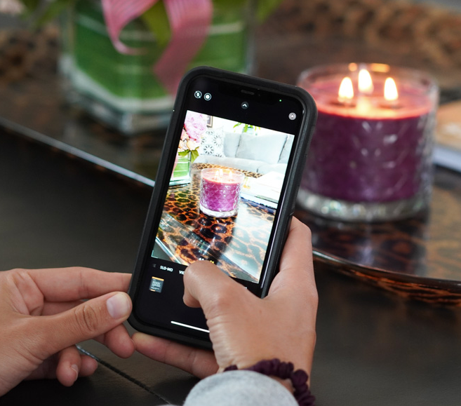 Gold Canton pomegranate candle is photographed using a phone. 
